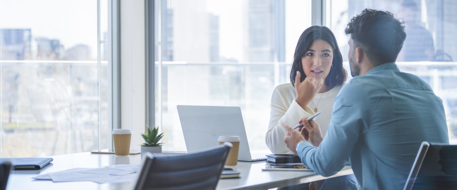 Business woman and man meeting in a conference room and talking Business woman and man meeting in a conference room and talking