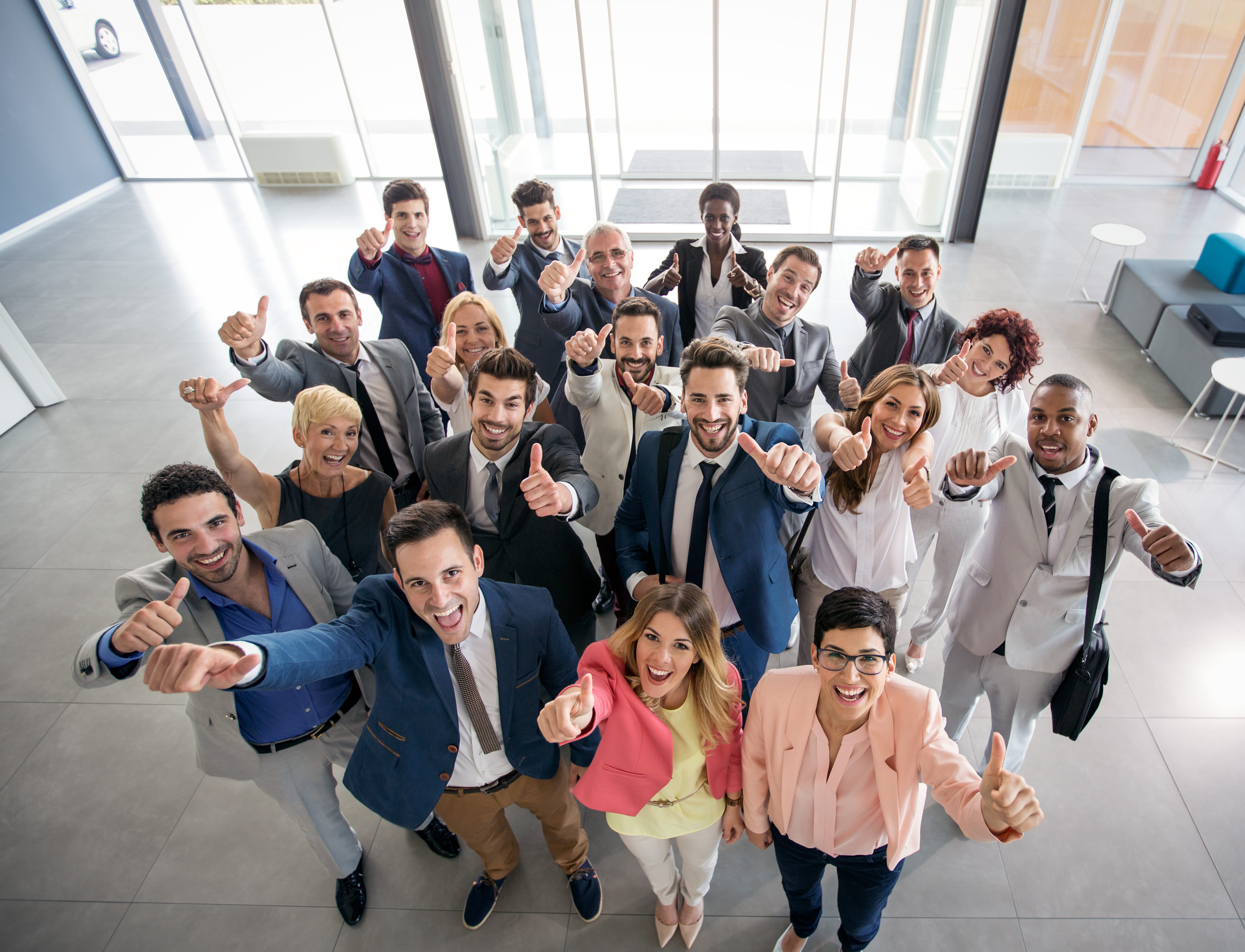 group of people from above with arms raised