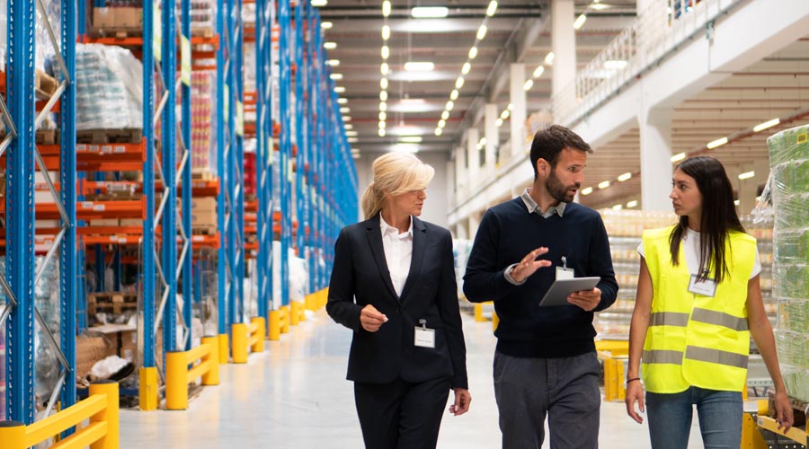 Logistics professionals conducting a site inspection in a warehouse Logistics professionals conducting a site inspection in a warehouse