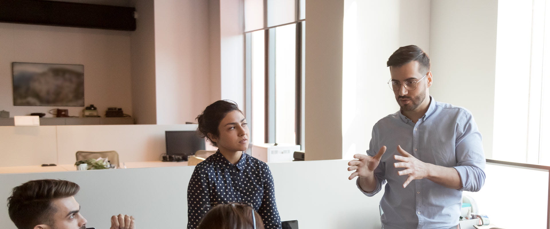 man speaking to group in conference room